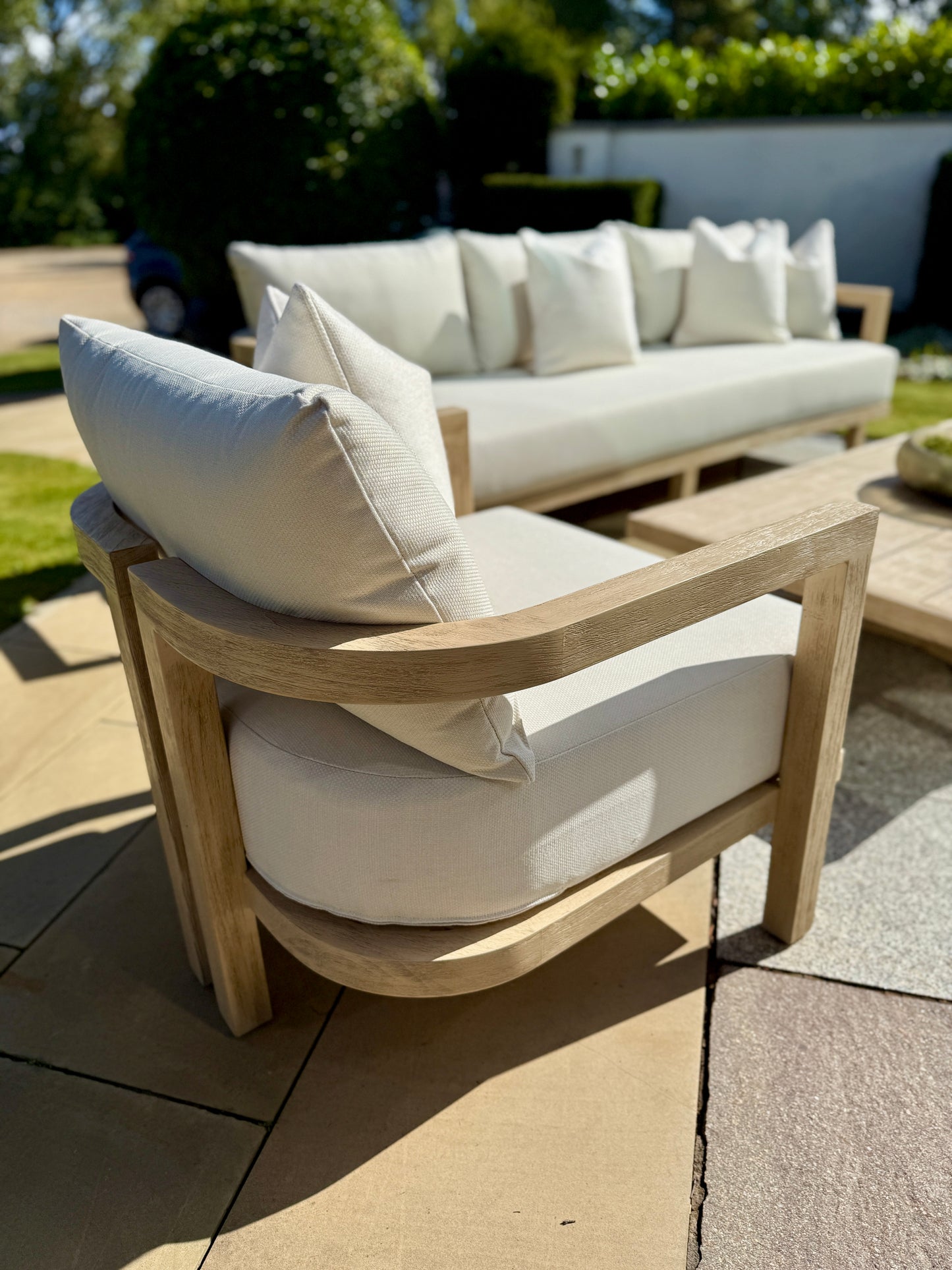 Hamilton Teak armchair lifestyle shot in garden patio setting